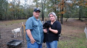 Boyd and Kandra Giannini with one of their surviving baby goats on their farm in Franklinton.